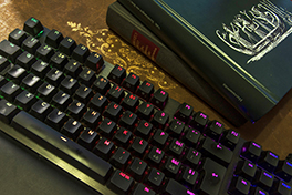 Eine bunt leuchtende Tastatur neben dicken Geschichtsbüchern